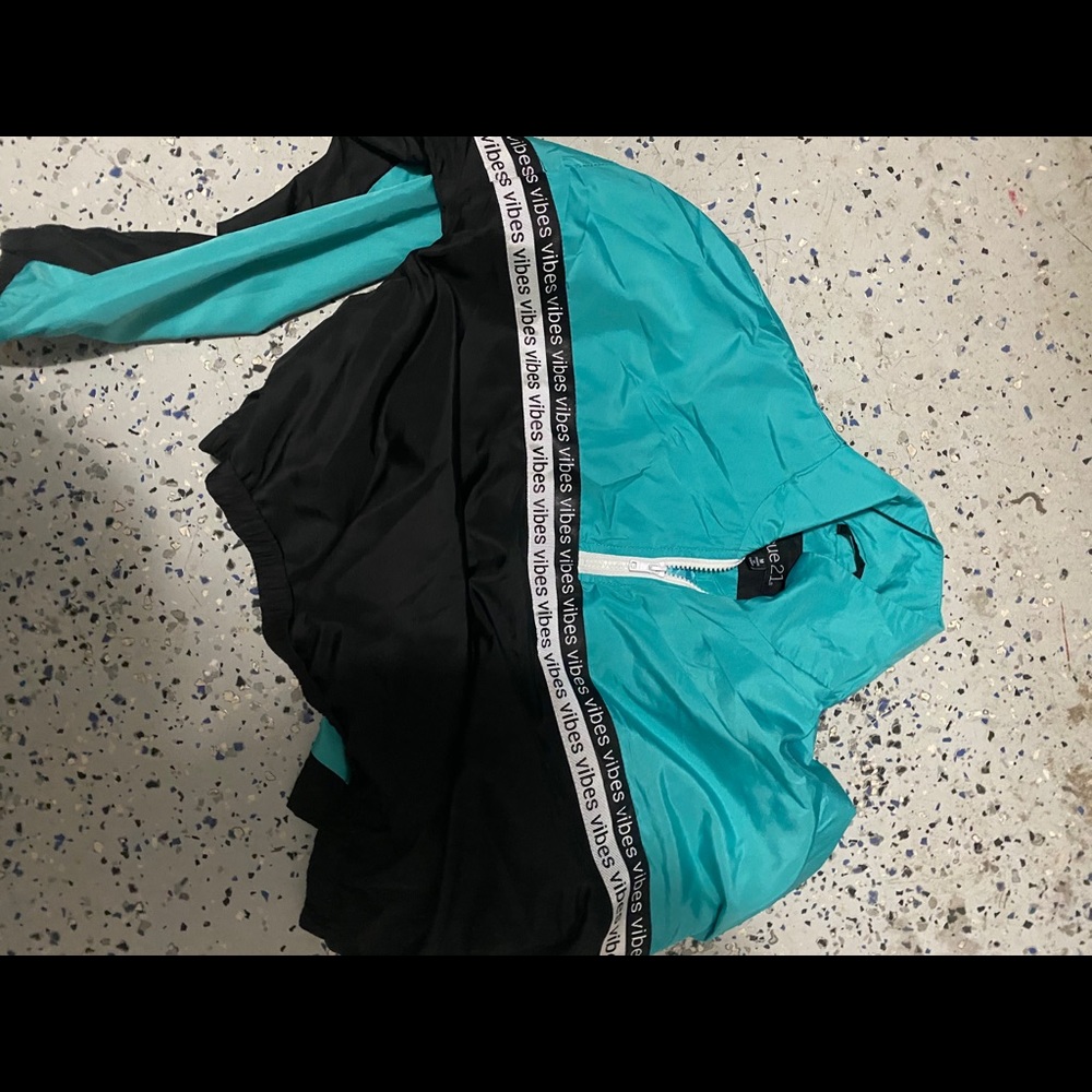 A teal n black rue21 wind breaker